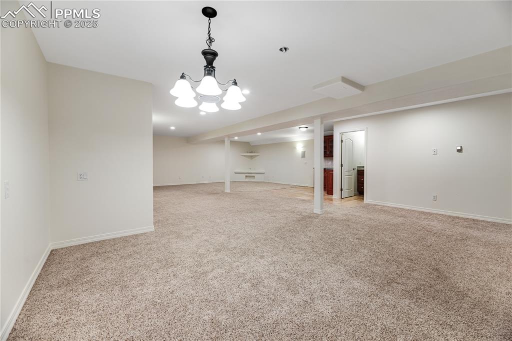 Image 45 of 48: Finished basement featuring light colored carpet and baseboards