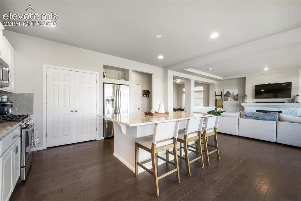 Image 12 of 48: Open-concept design featuring wood-finish flooring, recessed lighting, and 
