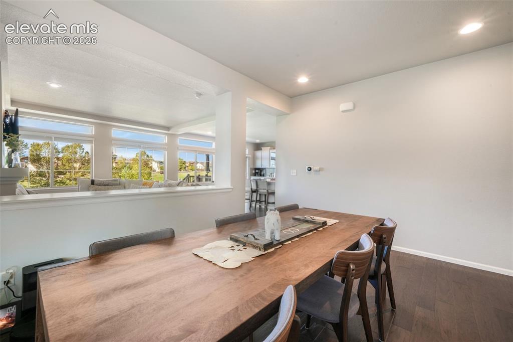 Image 16 of 48: Recessed lighting, wood-finish flooring, half-wall with cap, and multiple w