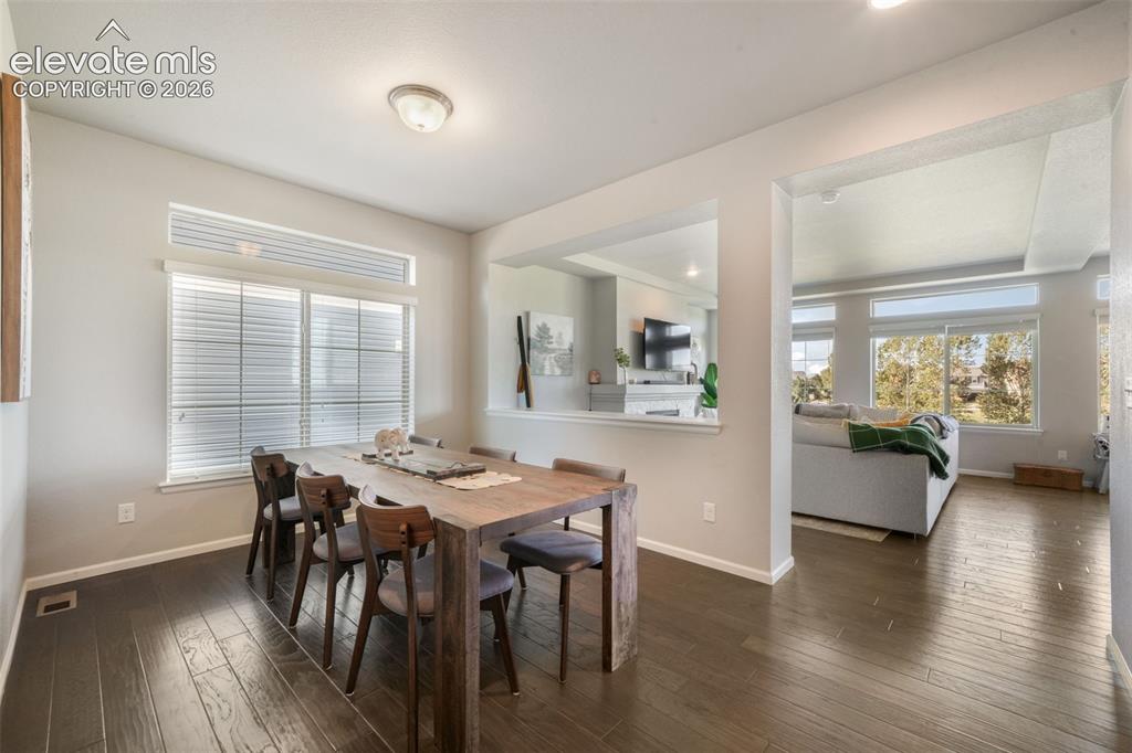 Image 17 of 48: Wood-finish flooring throughout, large window with transom, recessed wall o