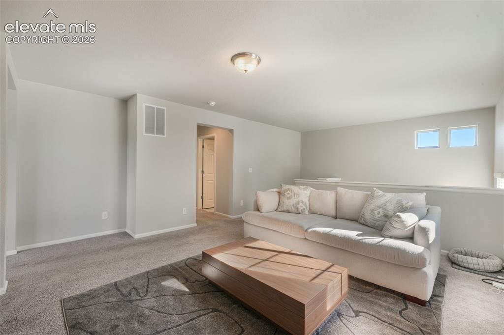 Image 21 of 48: Recessed ceiling light fixture, wall-to-wall carpeting, and upper-level win