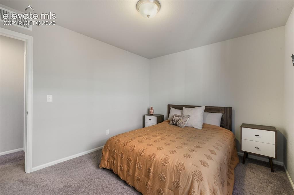 Image 30 of 48: Light gray walls complement the gray carpeting