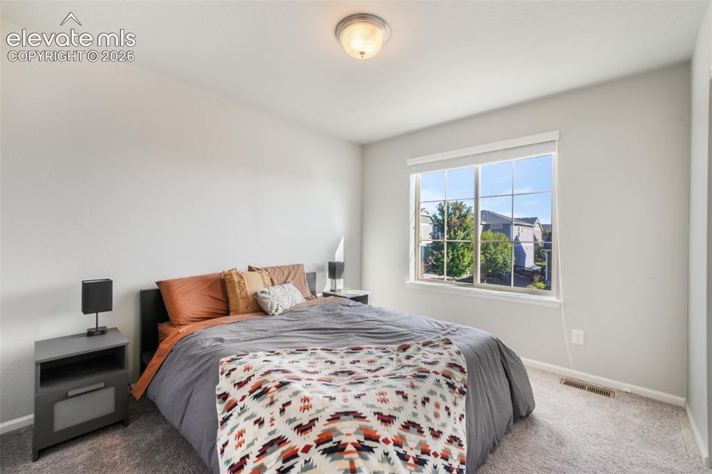 Image 32 of 48: Neutral wall palette with a double-pane window, carpeted flooring, and a ce