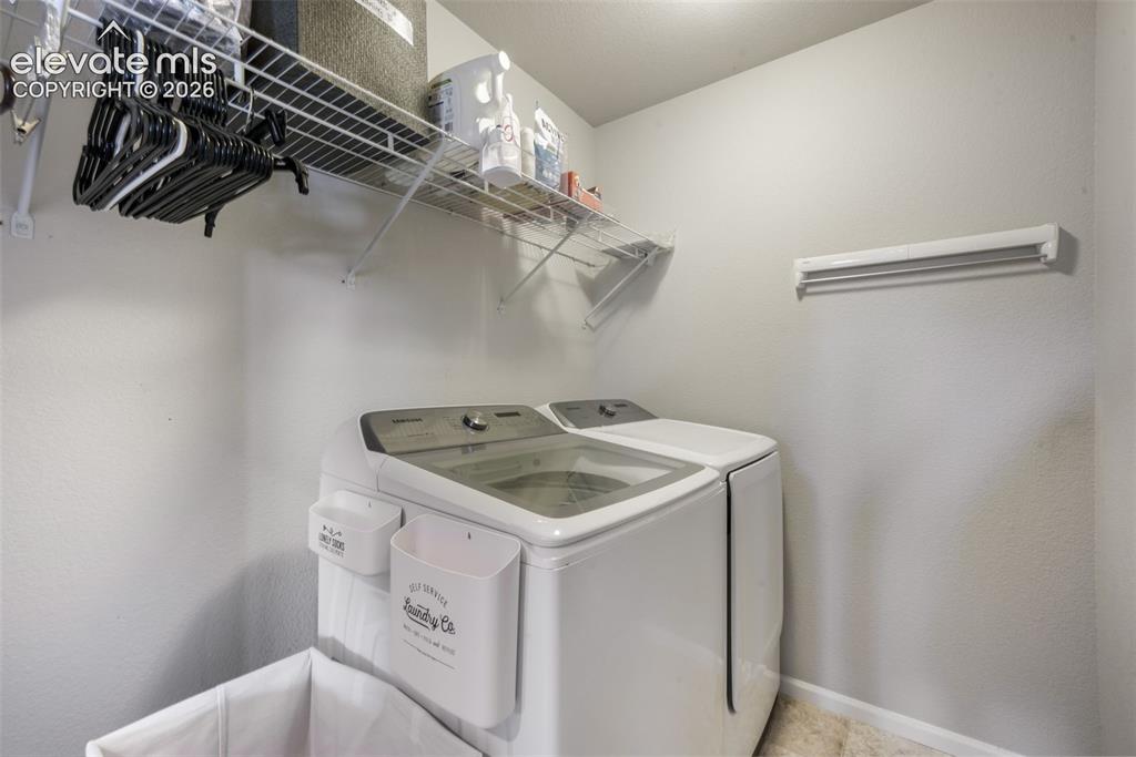 Image 36 of 48: 2nd floor Built-in wire shelving and a wall-mounted drying rack provide sto
