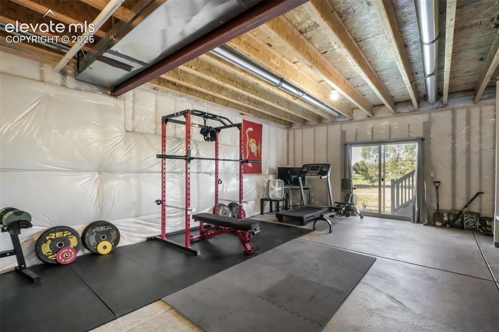 Image 39 of 48: Unfinished basement space with exposed ceiling joists and ductwork, featuri
