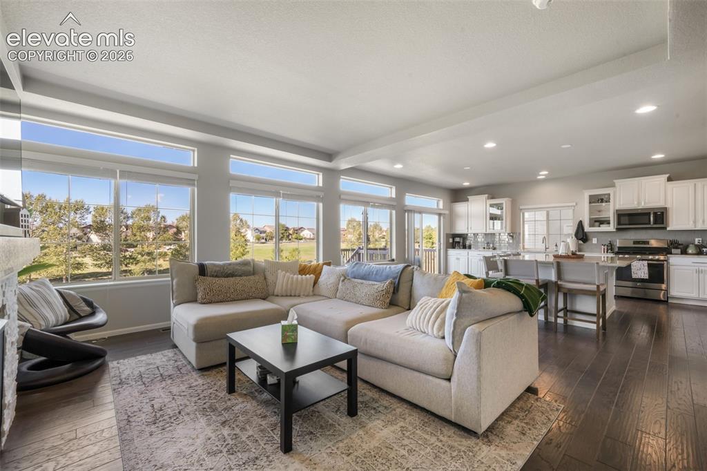 Image 4 of 48: Open-concept living space featuring wood-finish flooring, recessed lighting