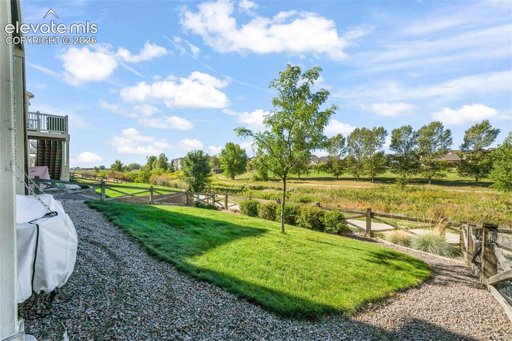 Image 43 of 48: Expansive outdoor space featuring a lower-level patio, upper-level deck, an