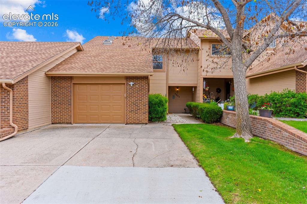 Image 1 of 32: Exterior featuring brick accents, attached garage, concrete driveway, and a