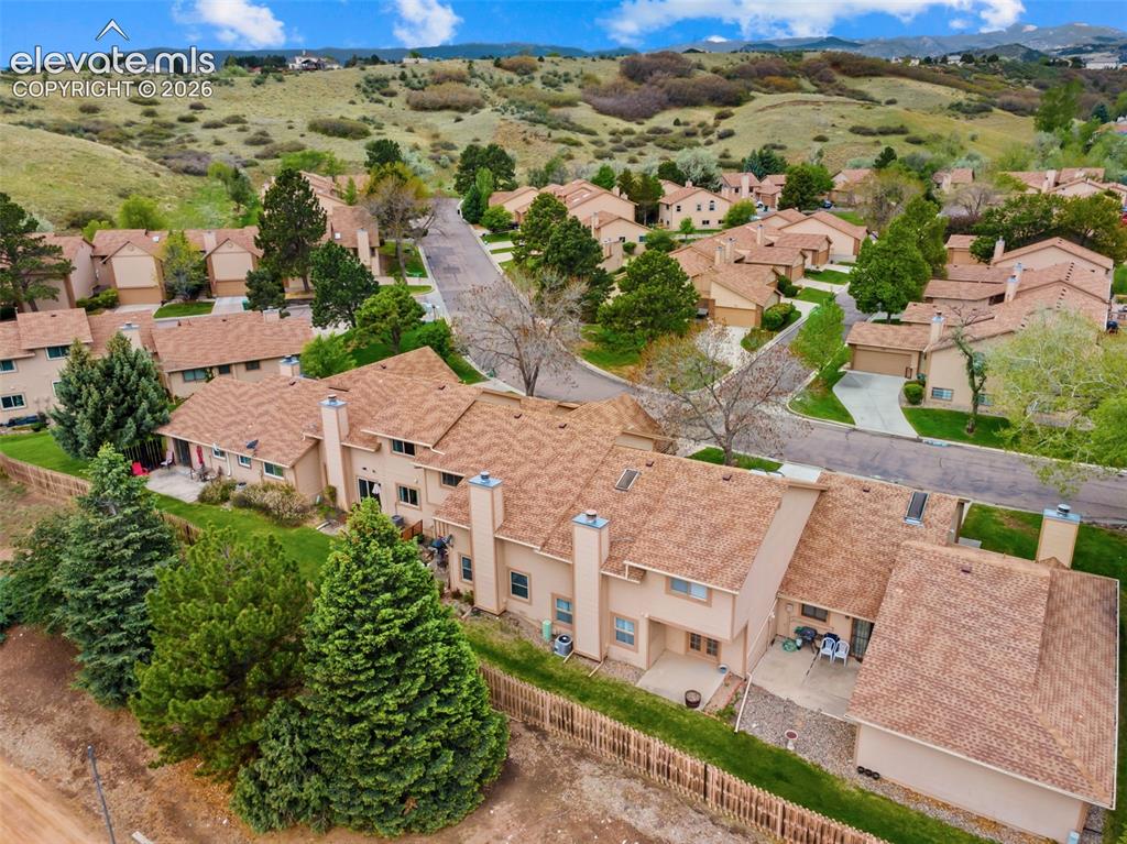 Image 30 of 32: Townhome community featuring neutral-toned exteriors with complementary bro