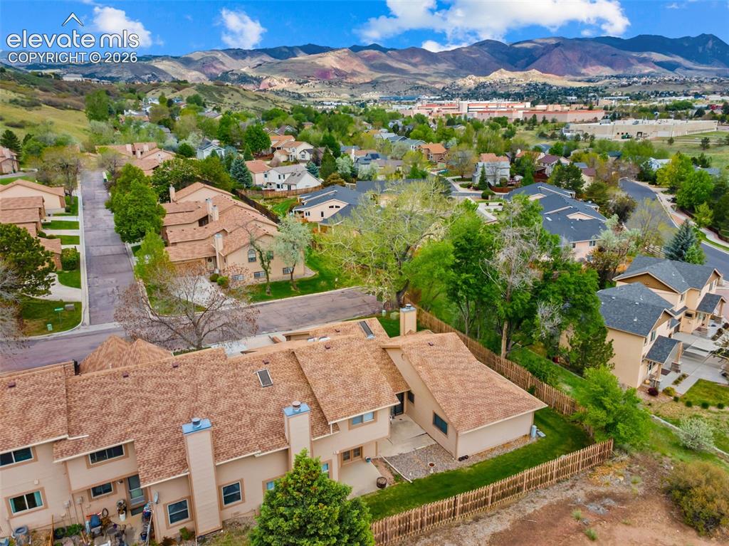 Image 31 of 32: Terraced homes featuring pitched roofs and stucco exteriors