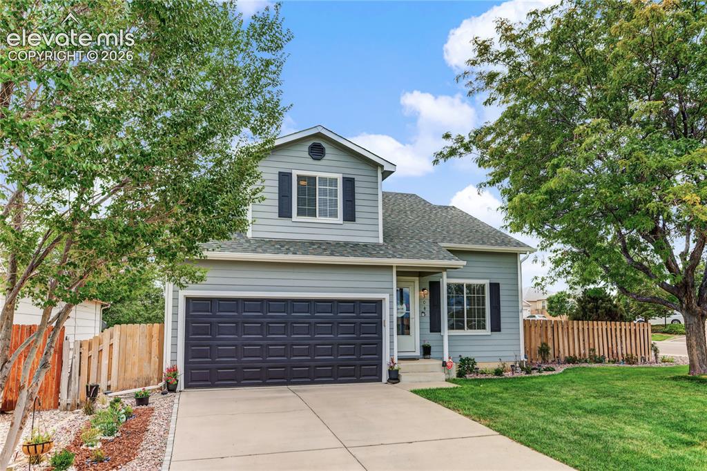 Image 2 of 36: Two-story exterior with siding, a two-car garage, a concrete driveway, and