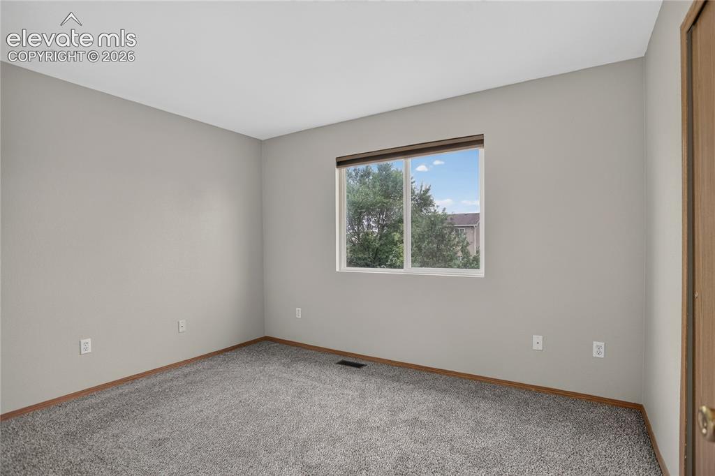 Image 25 of 36: Carpeted flooring with a window offering natural illumination