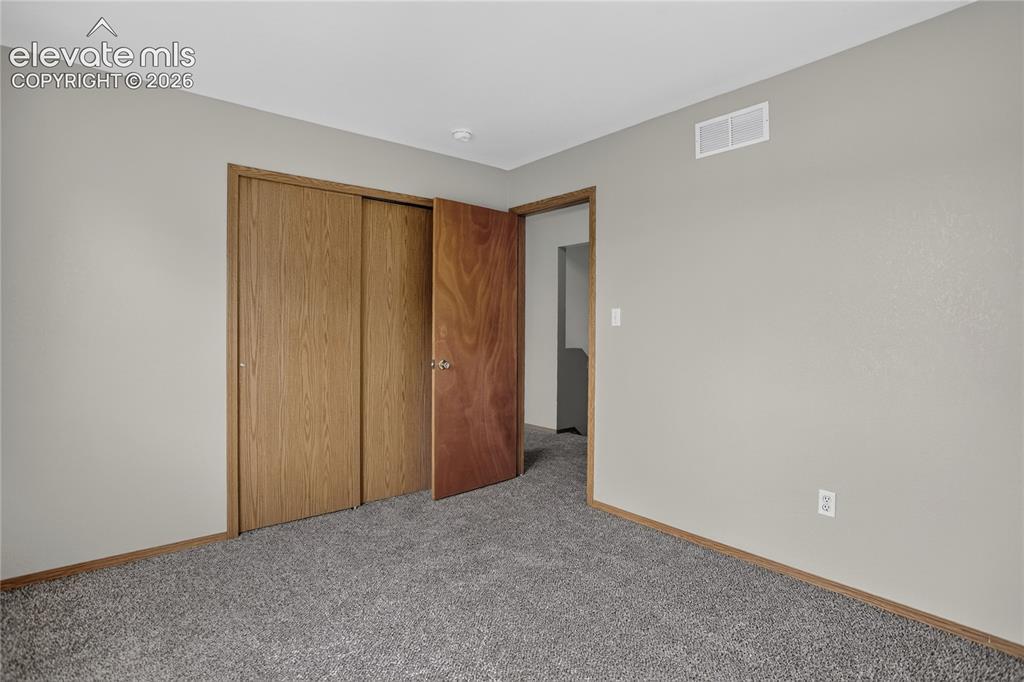 Image 26 of 36: Gray carpet flooring with light gray wall paint