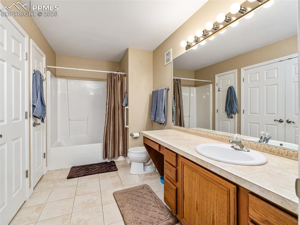 Image 18 of 25: Main Bathroom with laundry area