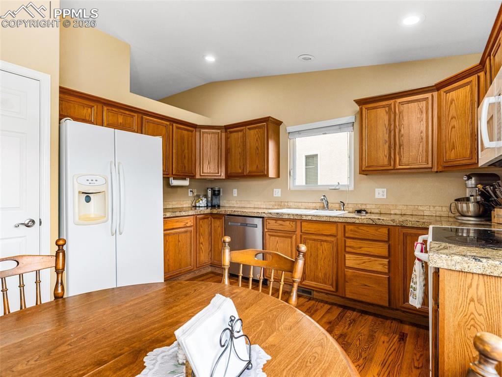 Image 3 of 25: Nice size kitchen with room for full table, granite counters, pantry and a