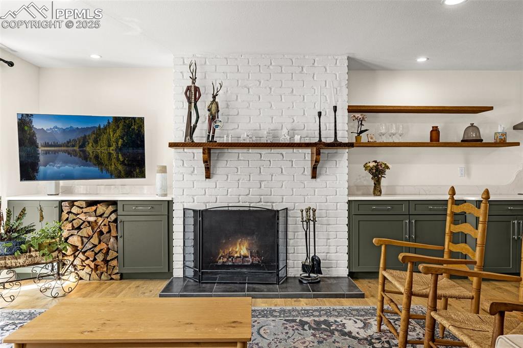 Image 10 of 43: Living room featuring dark wood-style flooring, recessed lighting, and a fi