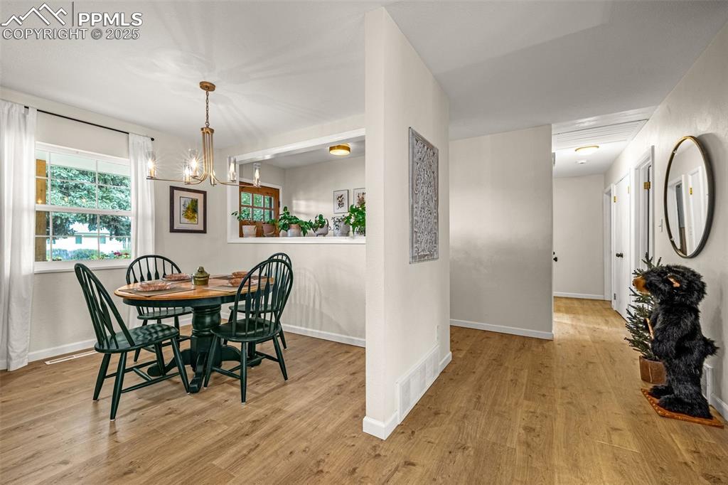 Image 13 of 43: Dining area featuring light wood-style flooring and a chandelier