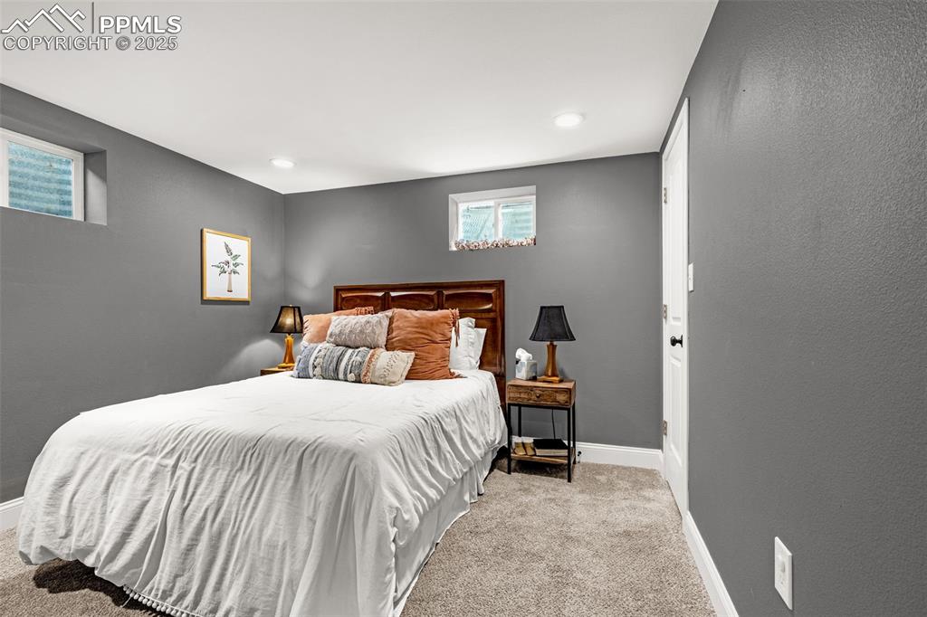 Image 17 of 43: Bedroom featuring light carpet and a textured wall