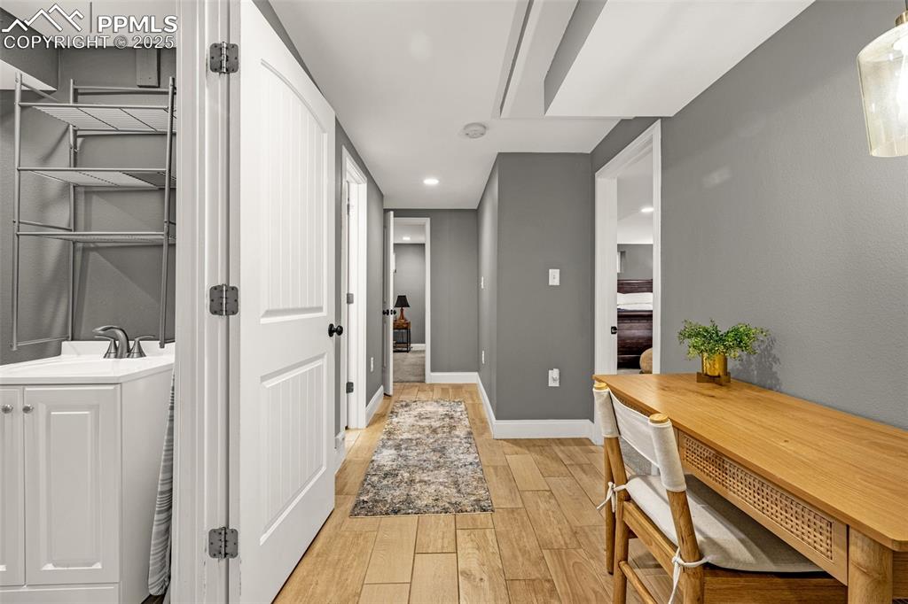 Image 22 of 43: Corridor featuring light wood-style floors and recessed lighting