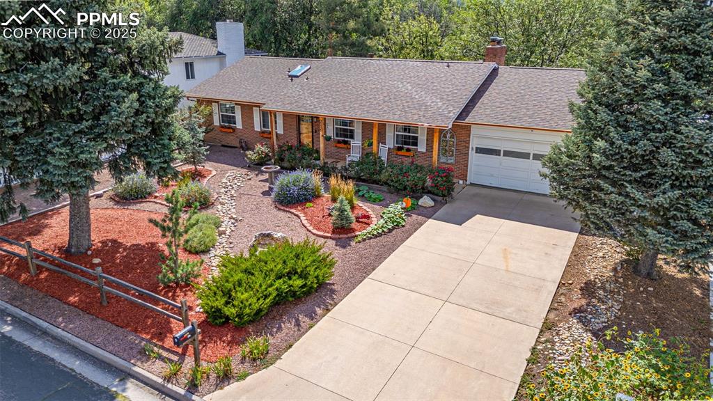 Image 38 of 43: View of front of property with a chimney, a shingled roof, brick siding, an