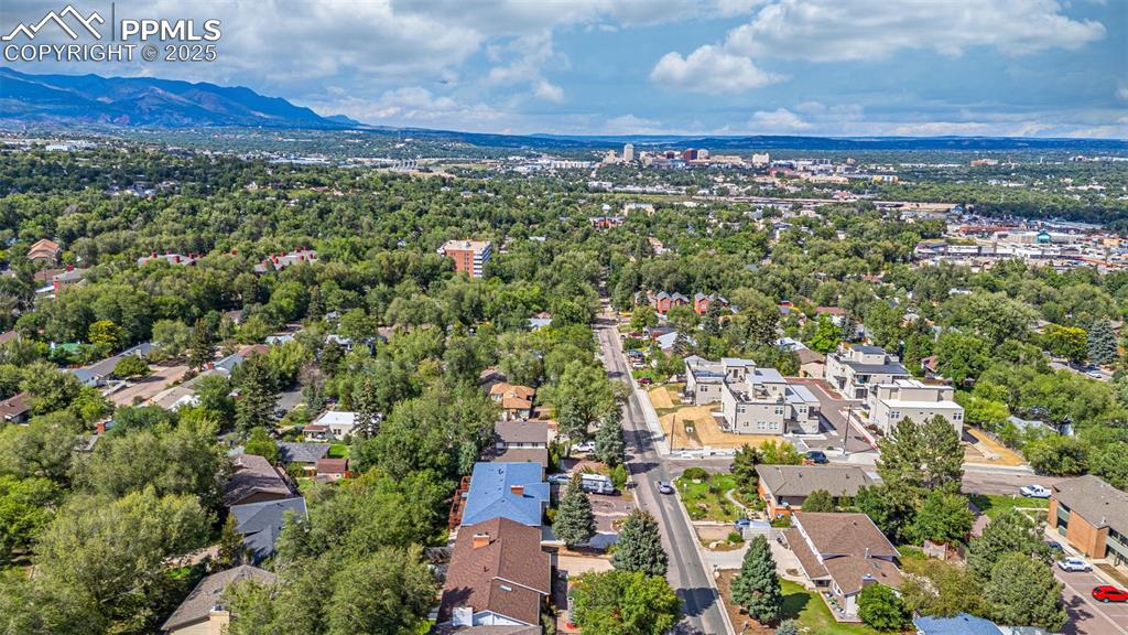 Image 42 of 43: Aerial view of residential area with a mountainous background