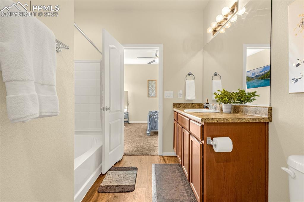 Image 16 of 28: Bathroom featuring shower / bathing tub combination, wood finished floors, 
