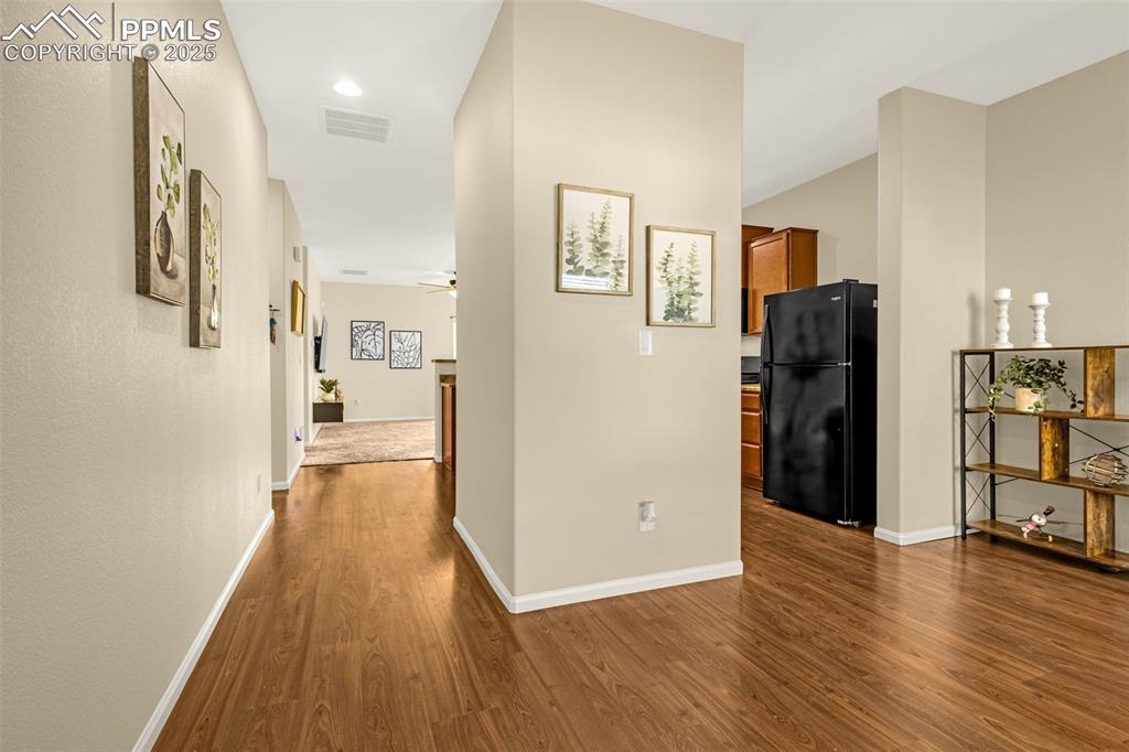 Image 3 of 28: Hall featuring visible vents, baseboards, and dark wood finished floors