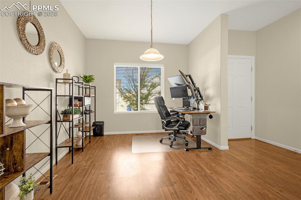 Image 9 of 28: Office space featuring baseboards and wood finished floors