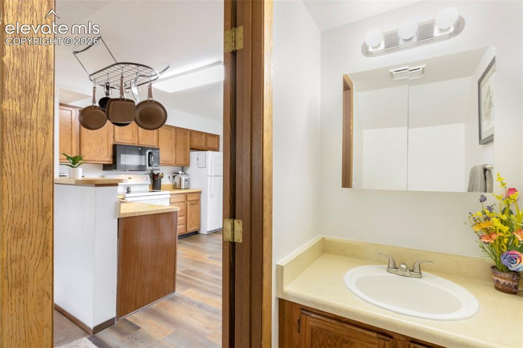 Image 14 of 26: Bathroom vanity with an integrated sink and base cabinetry