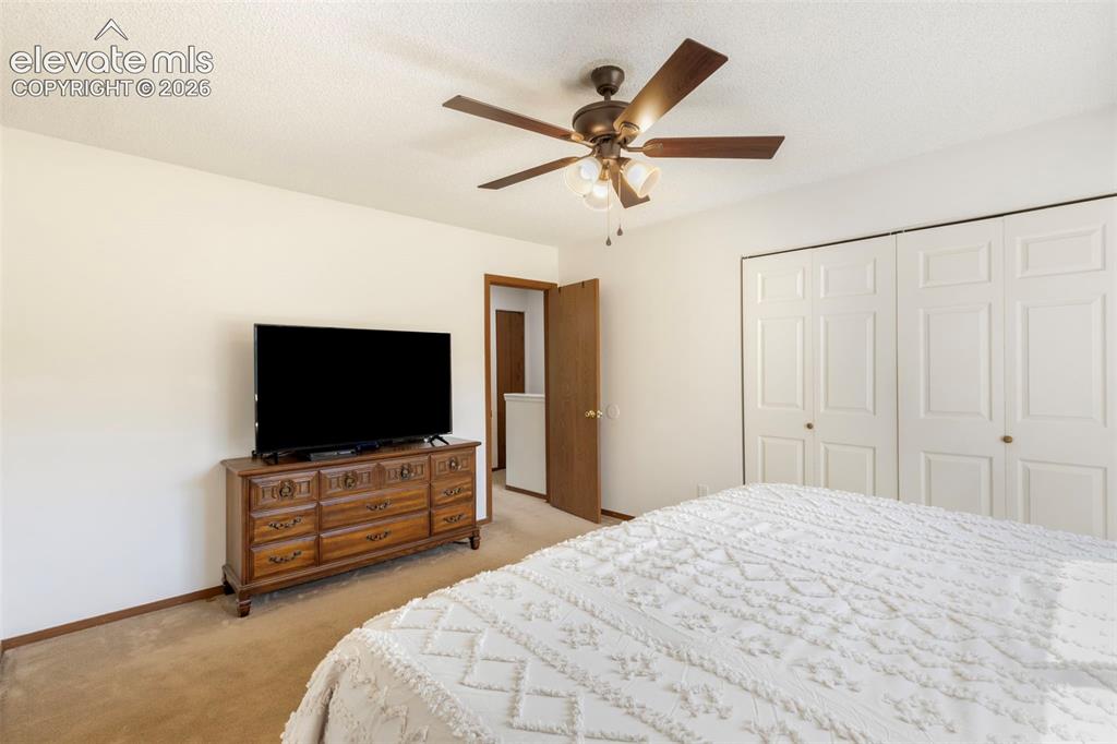 Image 17 of 26: Spacious room featuring neutral carpeting, a ceiling fan with integrated li