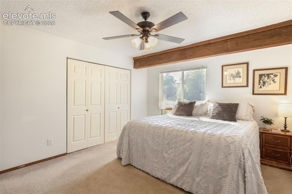 Image 18 of 26: Carpeted room featuring a ceiling fan with integrated lighting, wood-finish