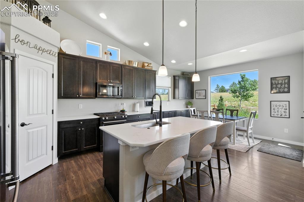 Image 11 of 40: Kitchen with healthy amount of natural light, stainless steel appliances, l