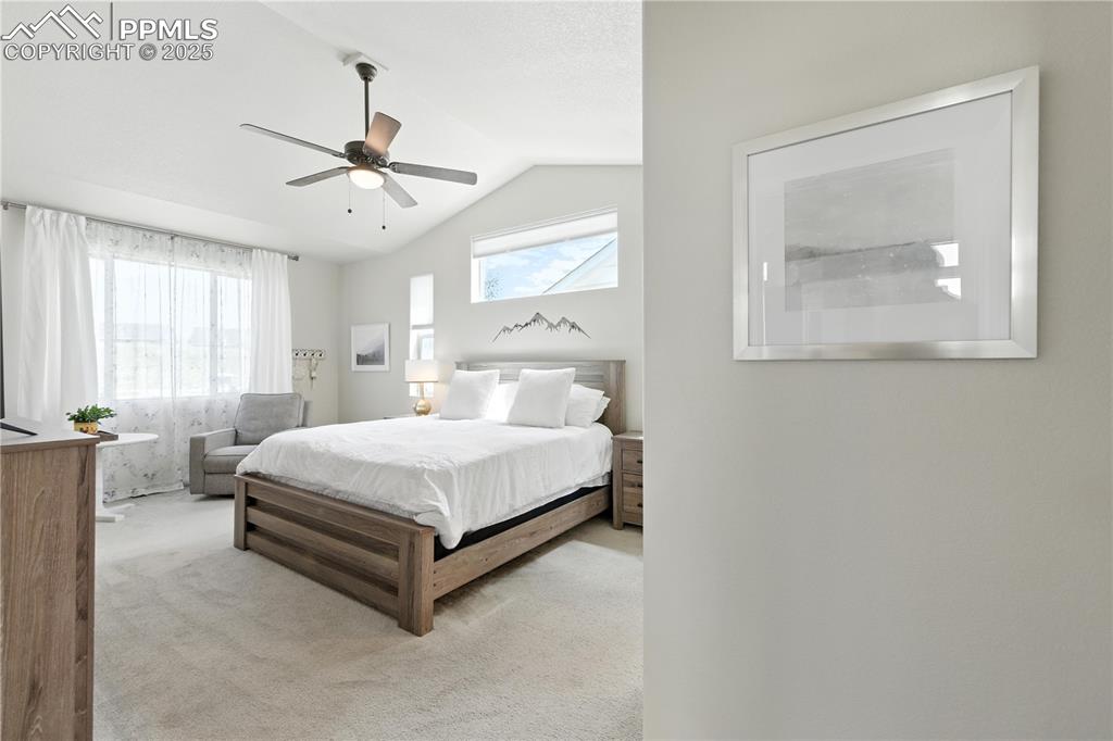 Image 17 of 40: Bedroom featuring carpet, lofted ceiling, and a ceiling fan