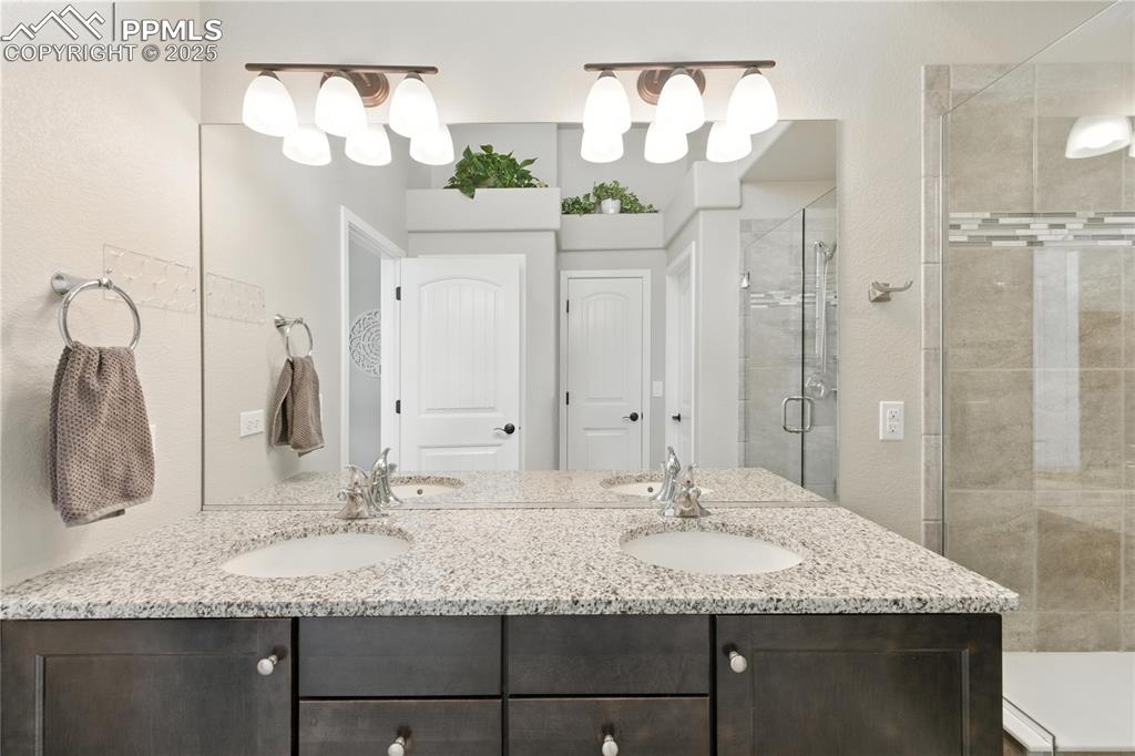 Image 19 of 40: Primary Bathroom with a shower stall and double vanity