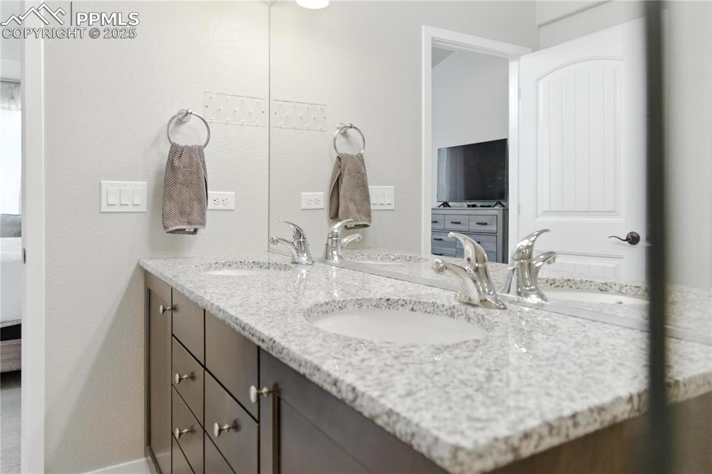 Image 20 of 40: Full bathroom with connected bathroom and double vanity