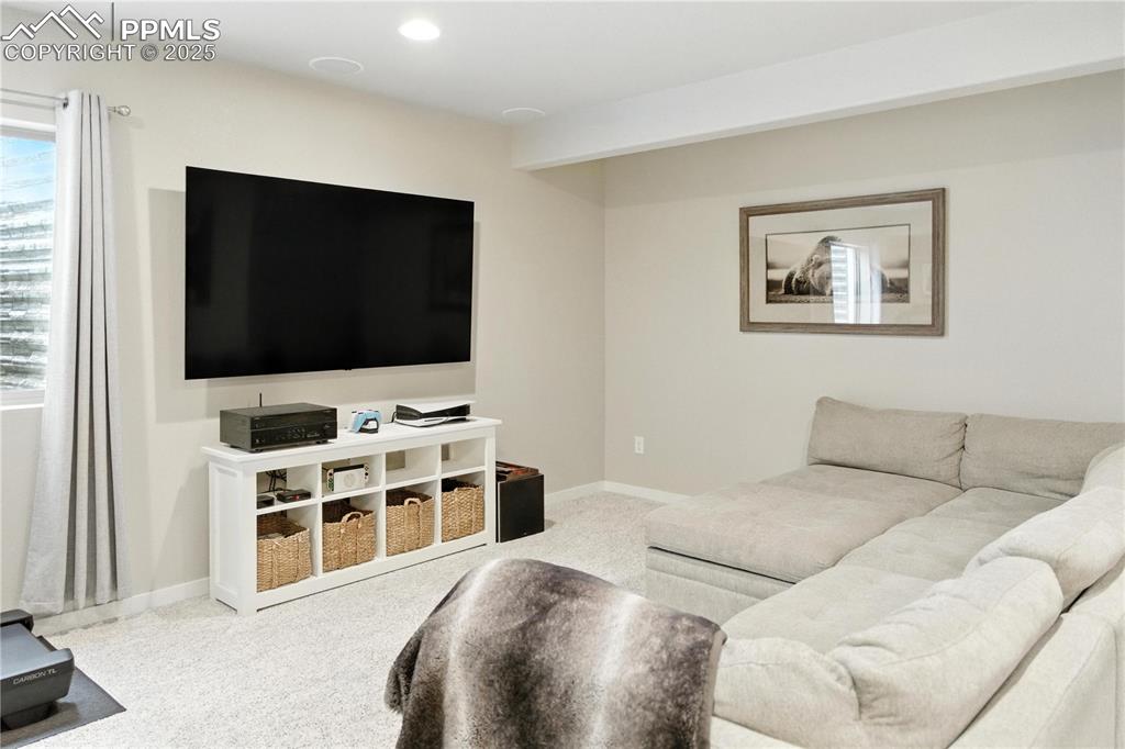 Image 24 of 40: Basement Living area with carpet flooring and baseboards
