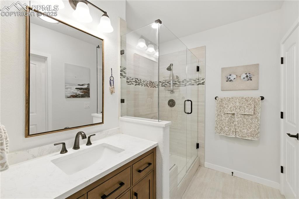 Image 29 of 40: Full bathroom with vanity and a shower stall