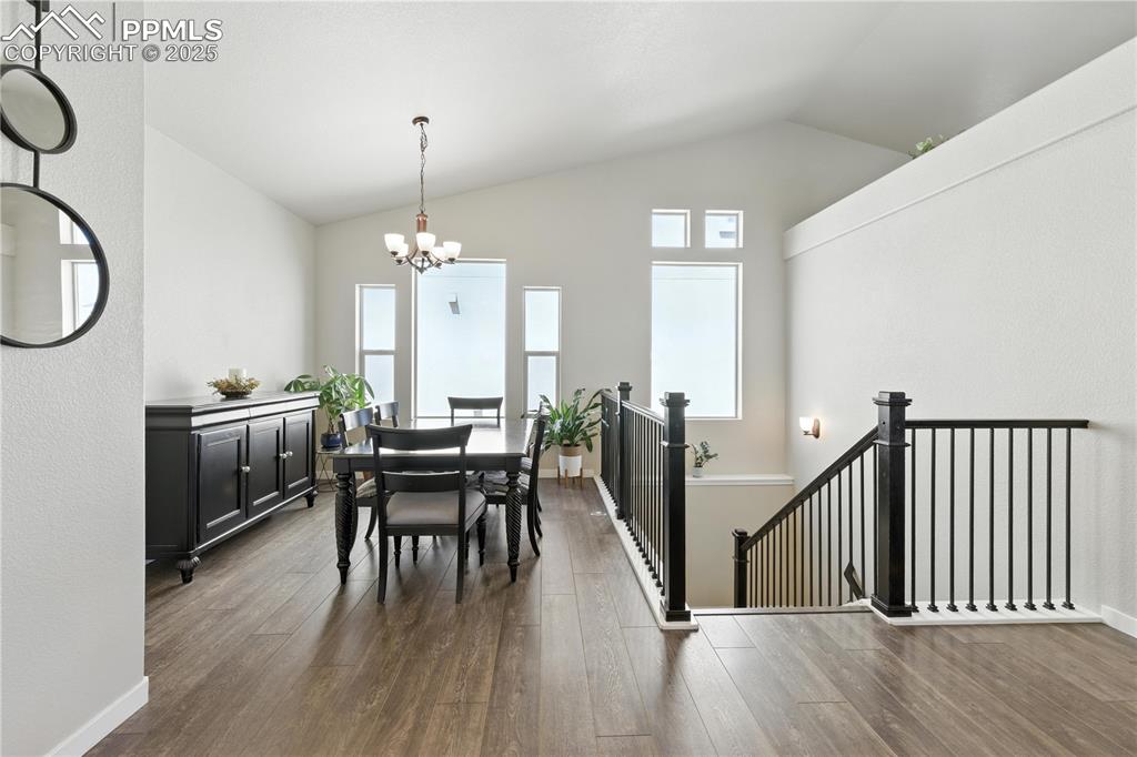 Image 3 of 40: Dining room with a chandelier, plenty of natural light, lofted ceiling, and