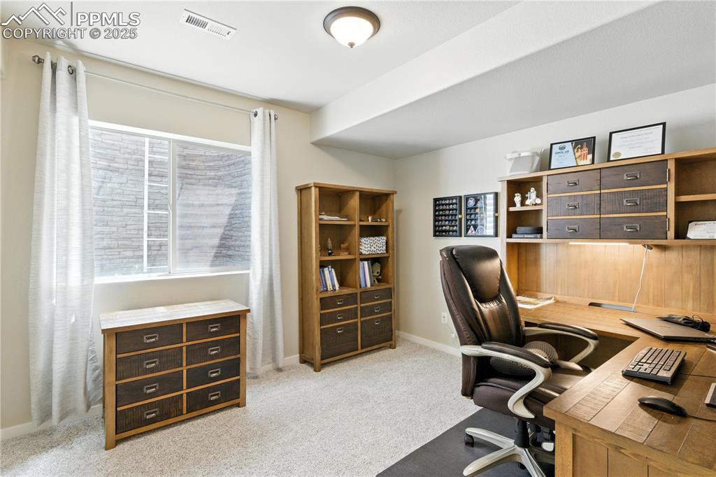 Image 31 of 40: Home office featuring light carpet and baseboards