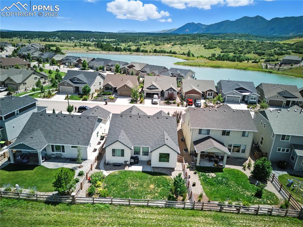 Image 40 of 40: Aerial perspective of suburban area with a water and mountain view