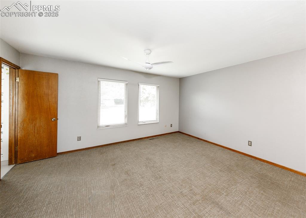 Image 16 of 50: 13x22 Primary Bedroom features a Ceiling Fan, Walk-in Closet and adjoining