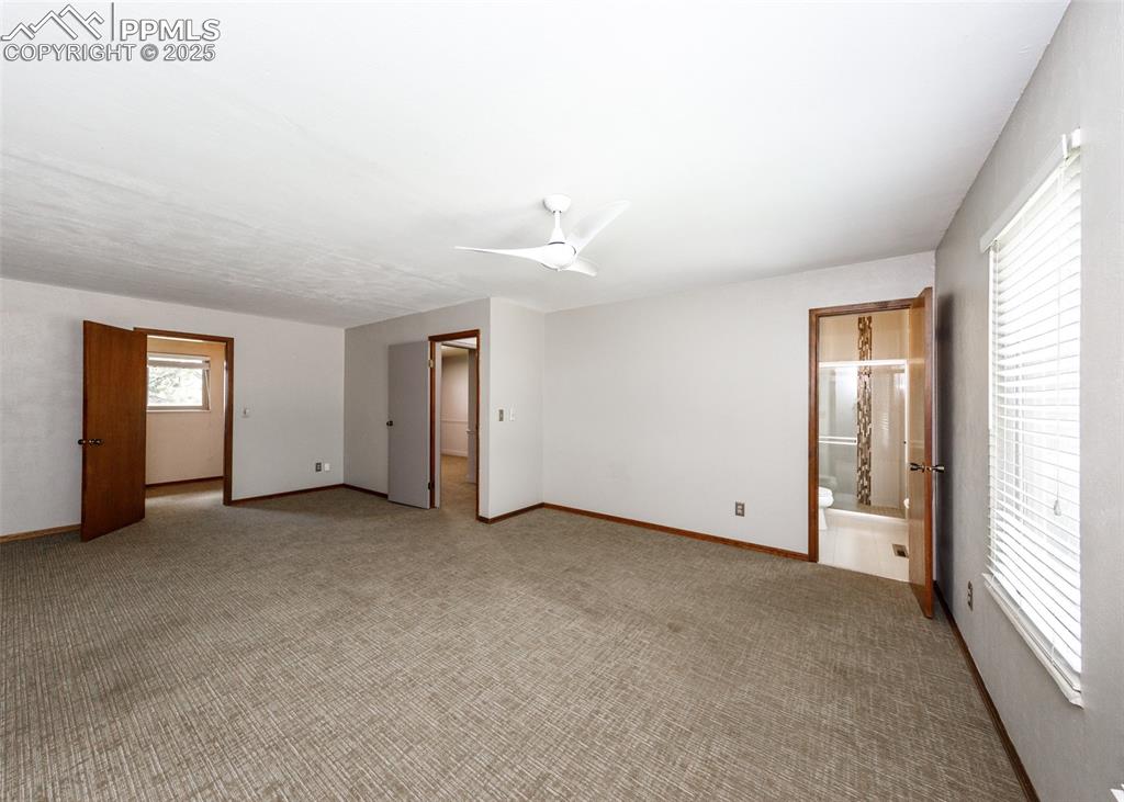 Image 17 of 50: View of Primary Bedroom looking toward Walk-in Closet and 3/4 Bath