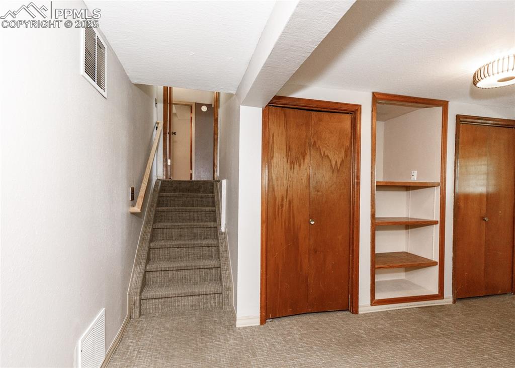 Image 35 of 50: 11x20 Bedroom with Closets and Shelving on Basement Level