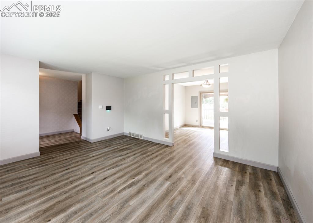 Image 7 of 50: View from Living Room toward Entry on left and Dining Room on right.