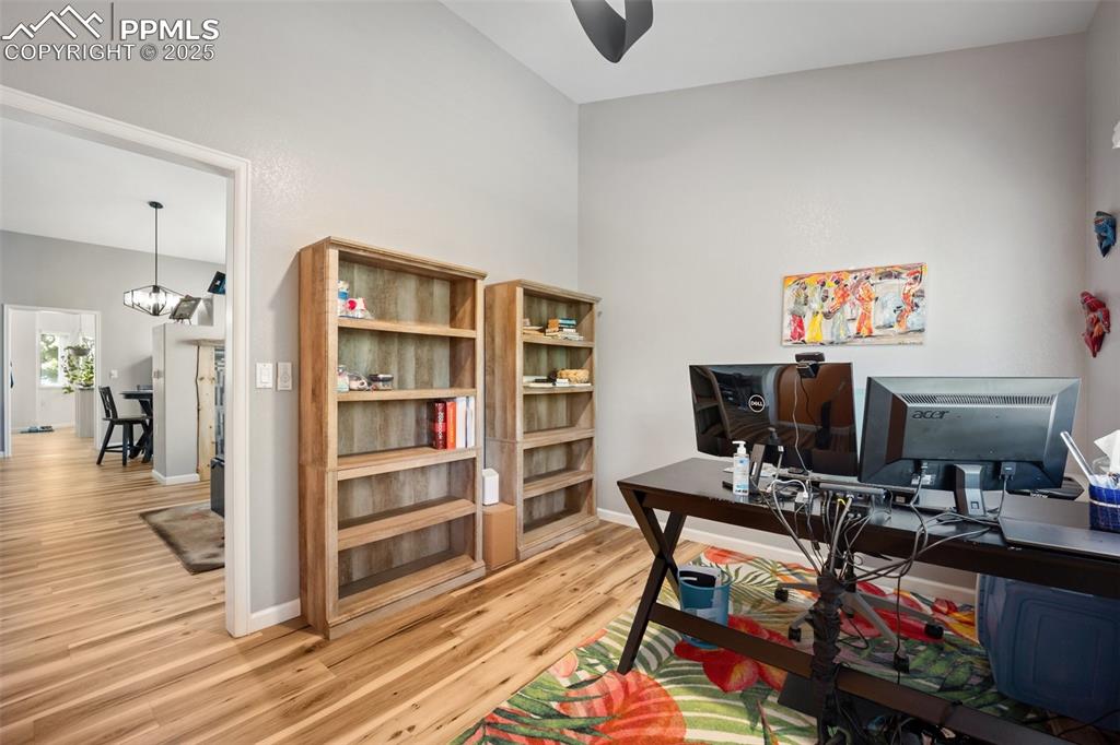 Image 19 of 50: Home office featuring light wood-type flooring, a chandelier, and a ceiling