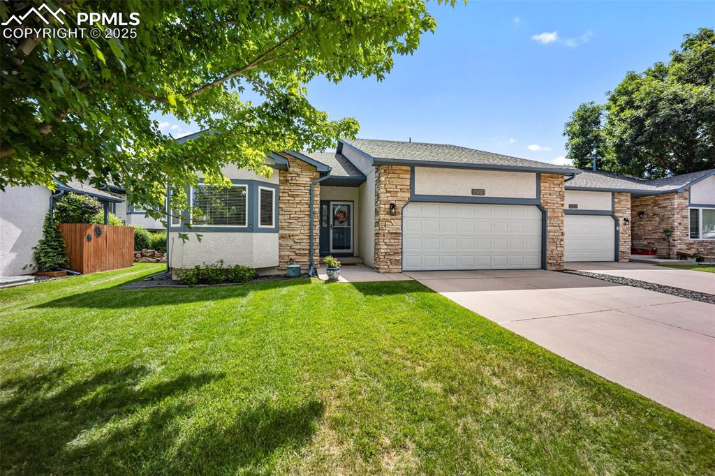 Image 2 of 50: View of front facade with an attached garage, concrete driveway, stucco sid
