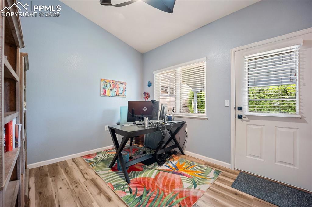 Image 21 of 50: Home office with a ceiling fan, light wood-type flooring, and lofted ceilin
