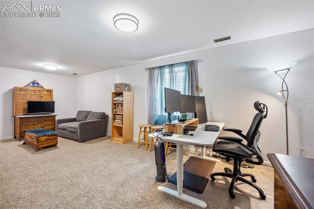 Image 34 of 50: Office area with light carpet and baseboards