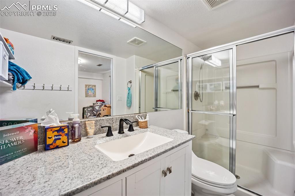 Image 39 of 50: Junior Suite bathroom with vanity and a stall shower