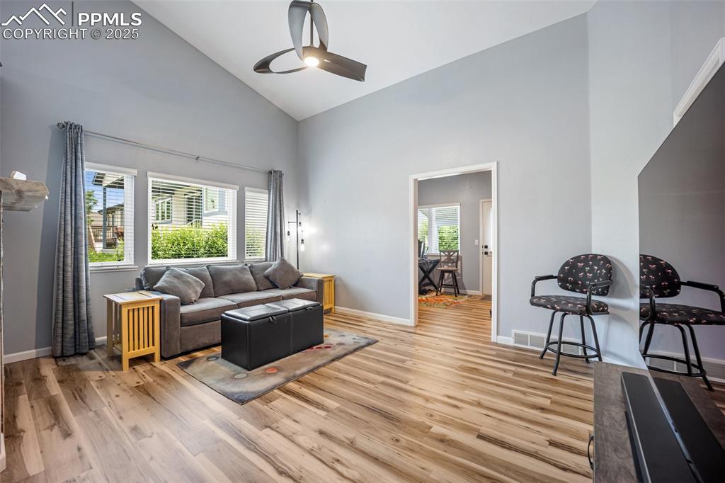 Image 4 of 50: Living room with high vaulted ceiling, healthy amount of natural light, a c